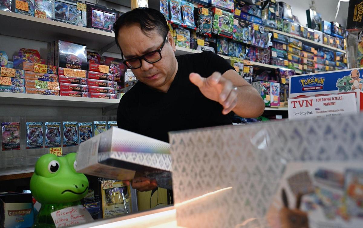 TVN Sports Cards & Collectibles owner Thor Phoeung puts the seven copies of the limited edition Pokemon Prismatic Evolution Super Premium Collection Box he offered through a lottery into a display case as he awaits new owners to pick up their lottery-won box set. Photographed Friday, May 16, 2025 in Fresno.