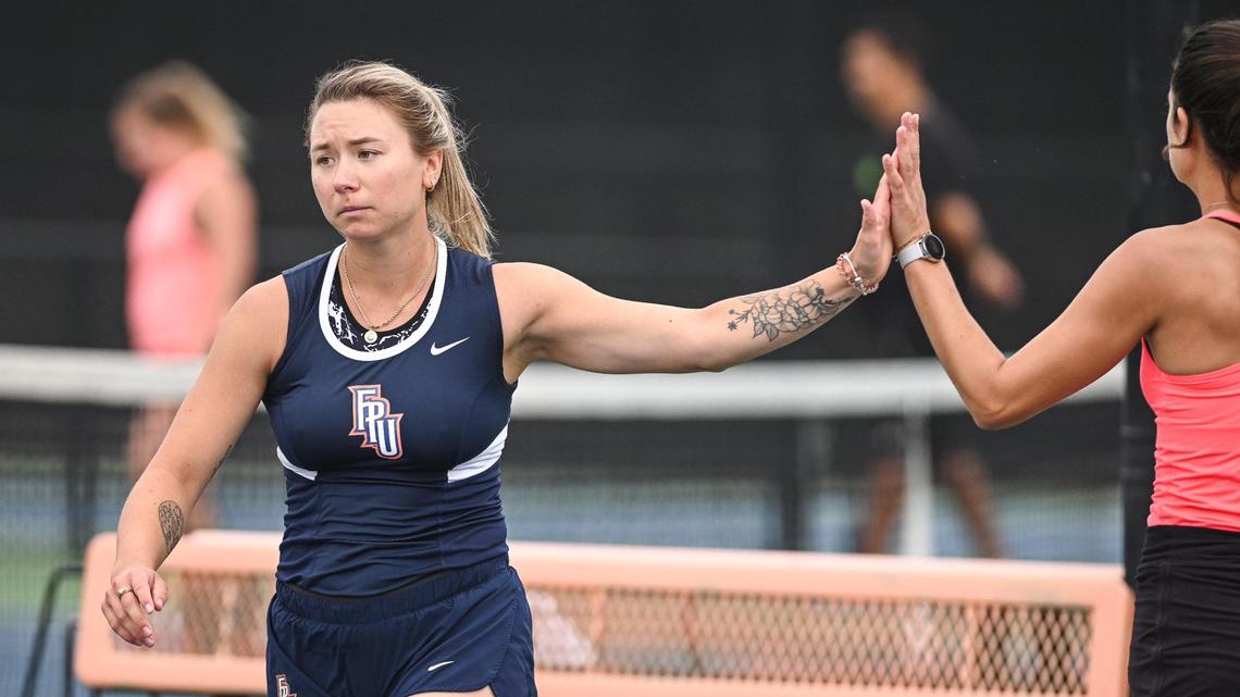 Mariia Borodii, from Zaporizhzhia, Ukraine, gets a high-five from teammate, roommate and close friend Sanne Brull, who is from The Netherlands during practice with the Fresno Pacific Sunbirds tennis team on Thursday, March 3, 2002.