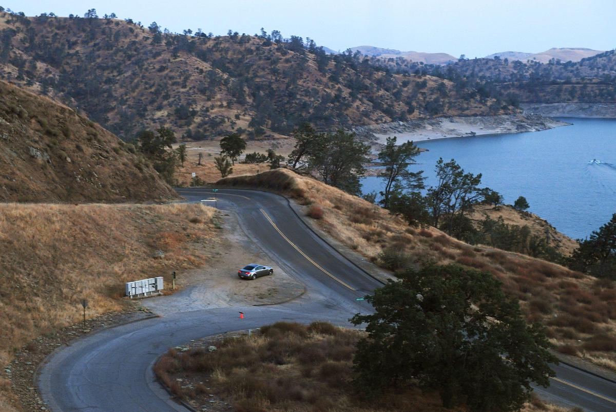 A car with two women prepares to leave a pullout after viewing the sunset over Millerton Lake from Sky Harbour Road Thursday, July 29, 2021 near Friant.