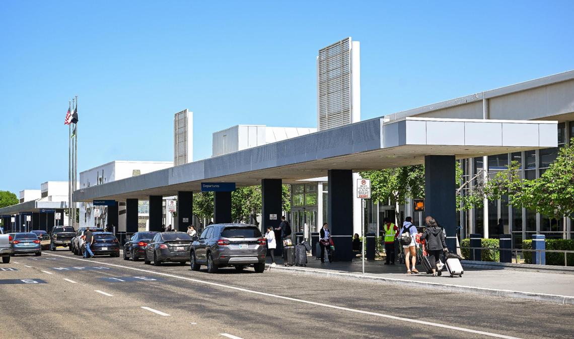 Vehicles drop off travelers in front of Fresno Yosemite International Airport.