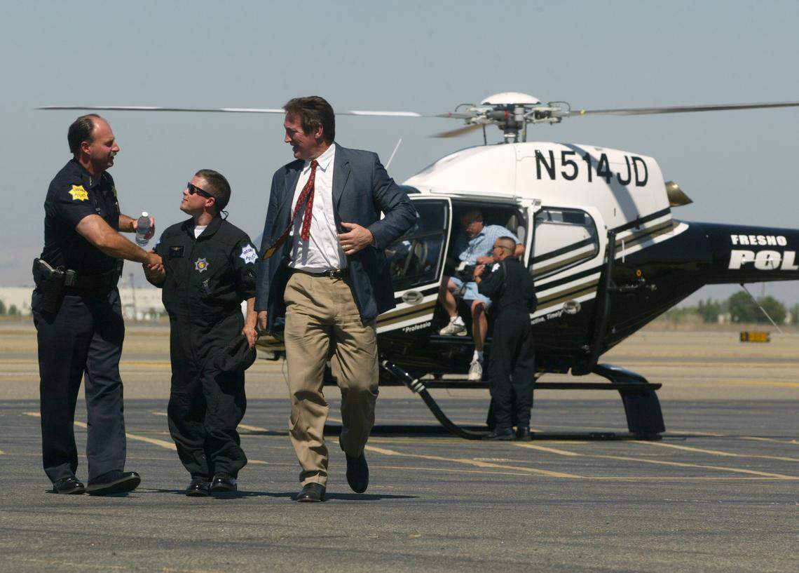 Jerry Dyer and Alan Autry thank Fresno Police Department Skywatch Operation maintenance technician Troy Wise after they flew in the new $1.5 million helicopter on July 3, 2003. Skywatch was an early highlight of Dyer’s nearly 20-year tenure as police chief.