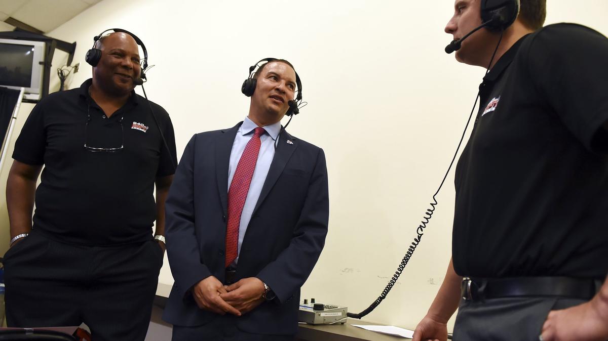 Justin Hutson, center, is interviewed by Bulldogs radio announcers Marc Jones, left, and Paul Loeffler after being introduced as Fresno State’s 19th head men’s basketball coach at a news conference Thursday, April 5, 2018 in Fresno.