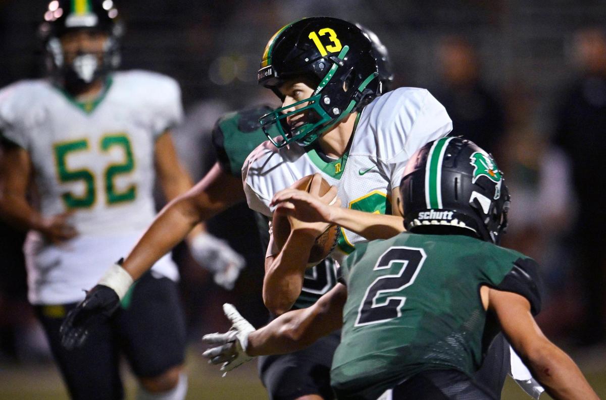 Roosevelt quarterback Jackson Kloster, center, finds an opening in Reedley’s defense on a scramble in the second half Friday night, Aug. 25, 2023 in Reedley. Roosevelt beat Reedley 39-32.