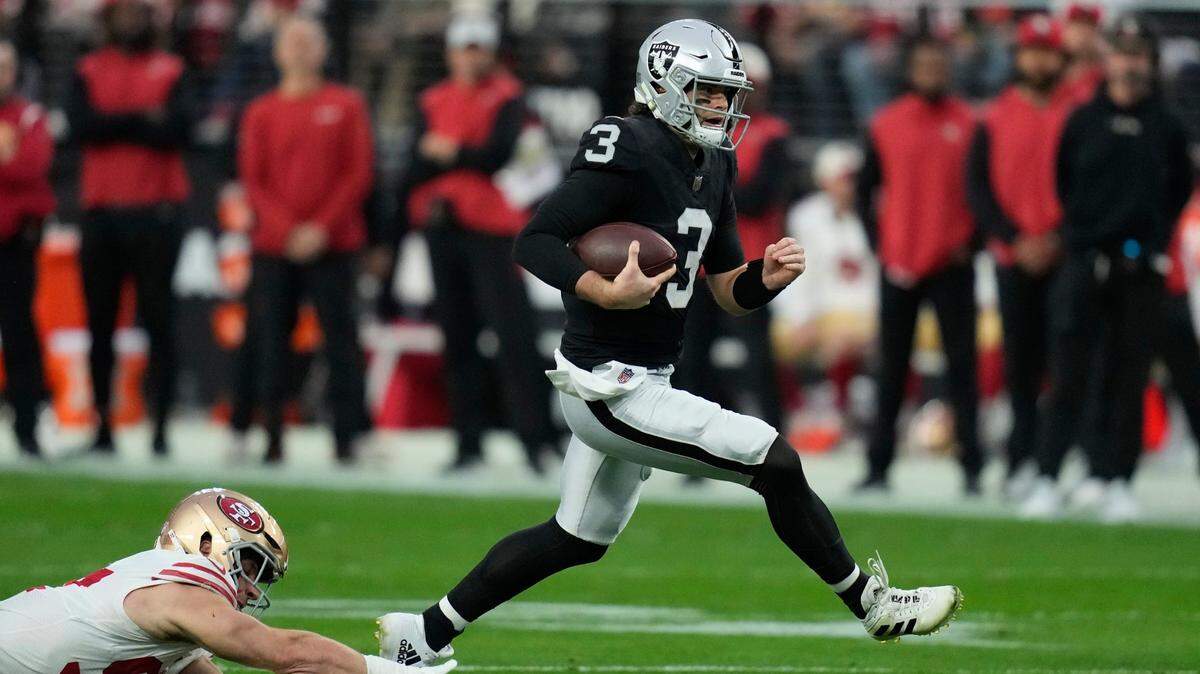 Las Vegas Raiders quarterback Jarrett Stidham evades a tackle by San Francisco 49ers defensive end Nick Bosa during the first half of an NFL football game between the San Francisco 49ers and Las Vegas Raiders, Sunday, Jan. 1, 2023, in Las Vegas.