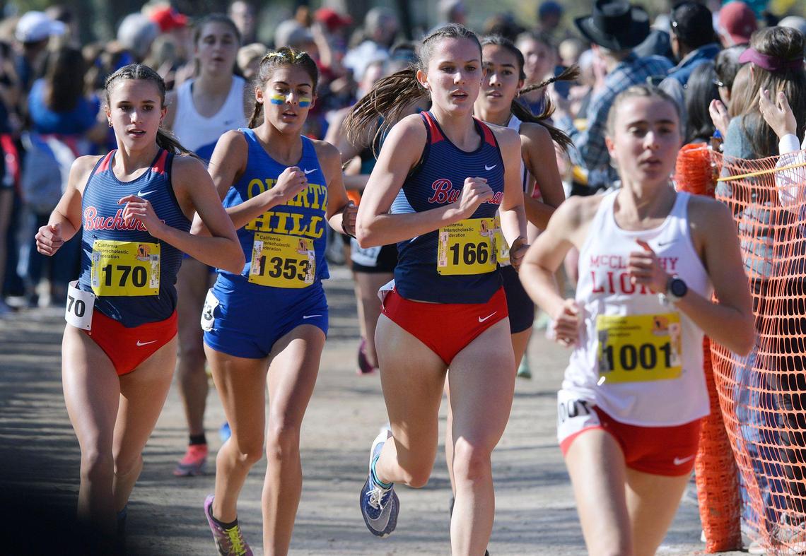 Buchanan’s Sydney Sundgren, far left, and Grace Hutchison, third from left, compete in the Division I race at the CIF State Cross Country Championships on Saturday, Nov. 27, 2021, at Woodward Park in Fresno.