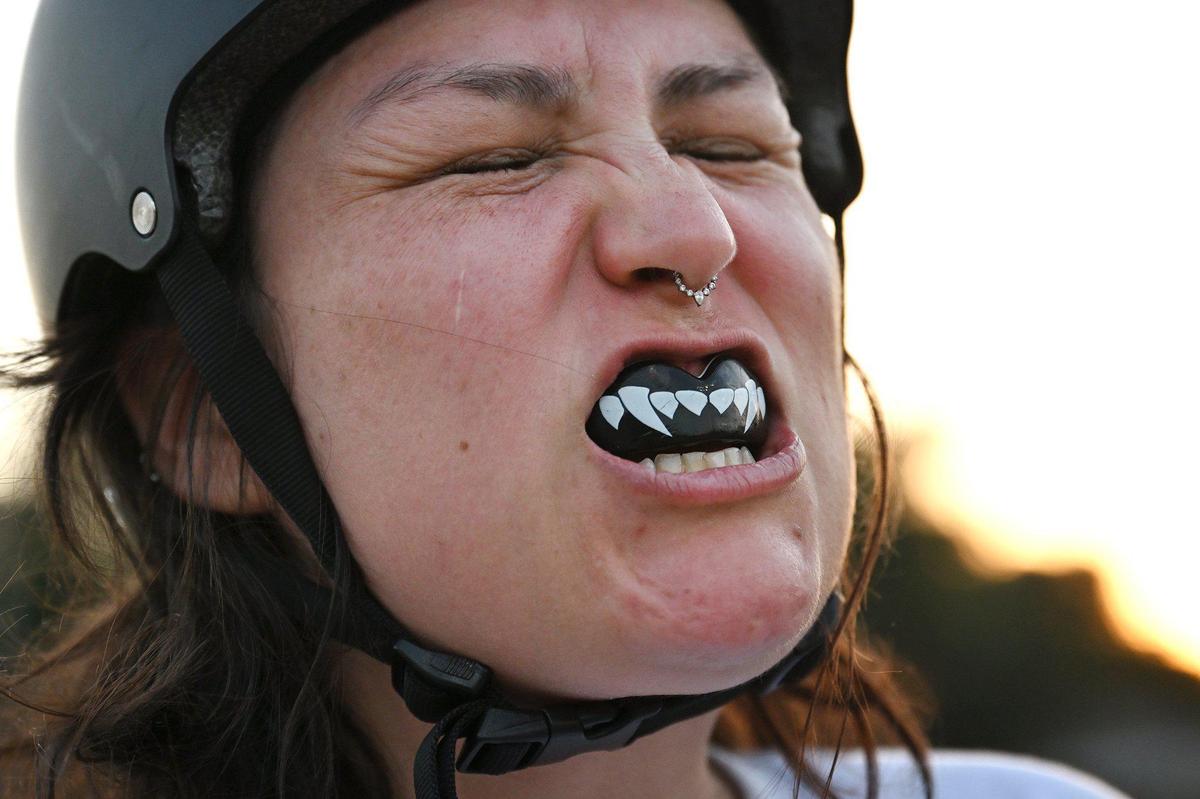 Maria “Kourt-knee Kar-Bash-U-In” Lewis shows off her mouth guard during Ash City Roller Derby’s practice on Thursday, May 6, 2025, in Fresno, California.