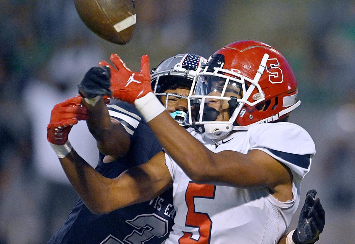 Clovis East’s Landon Nesbitt, left, interferes with a pass intended for Sanger’s Marquis Cropper, right, in the Silver Spear trophy game Thursday, Aug. 31, 2023 in Clovis. Clovis East won 42-21.