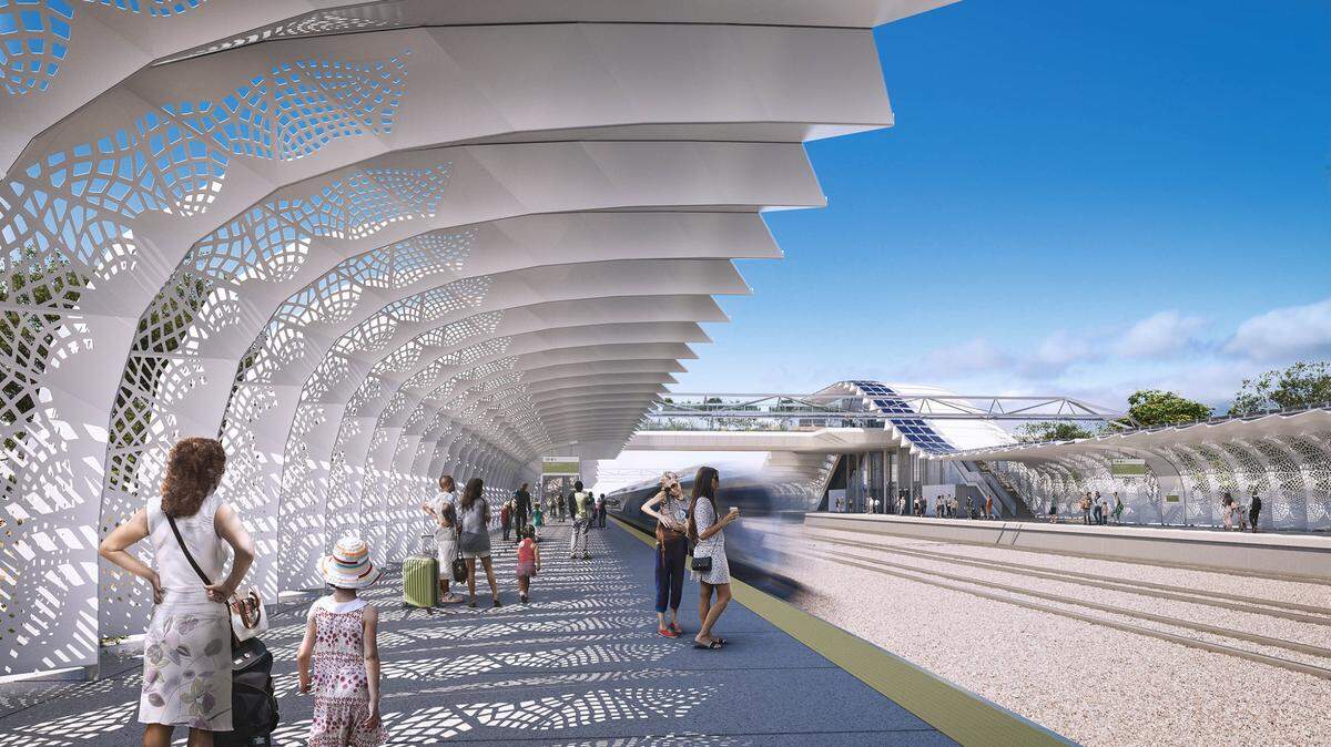 An artist’s rendering depicts passengers waiting on an open-air boarding platform at a future high-speed rail station in the central San Joaquin Valley. An elevated pedestrian bridge over the tracks allows passengers to get from one side of the station to the other.