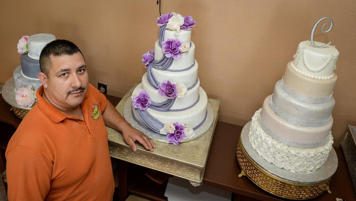 Owner Victor Callejas of Callejas Cakes stands near a few of his cakes on Thursday, June 14, 2018 at his new location which just opened at Shields Avenue near First Street in central Fresno three months ago. The bakery features a long list of various pastries, cakes, cookies and desserts.