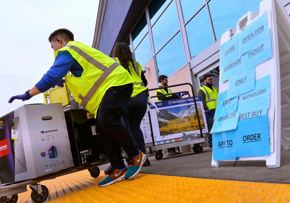 Staff at Best Buy offer curbside services on the first Saturday under sheltering orders Satirday, March 21, 2020 in Fresno.