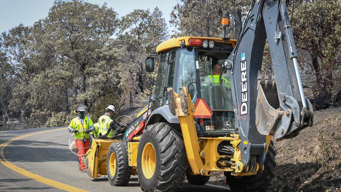 Crews work to removed downed power lines along Auberry Road in the evacuation zone at Pine Ridge on Saturday, Sept. 19, 2020.