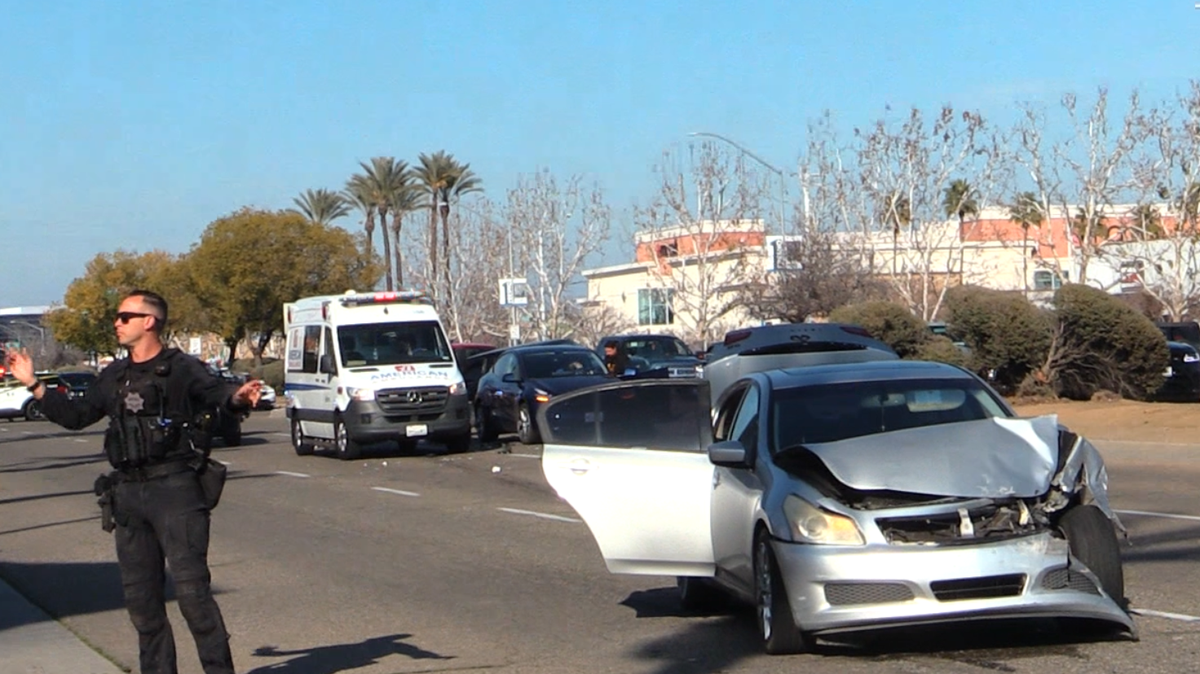 An officer tells traffic to go after a three-vehicle crash in Fresno, California on Sunday, Jan. 12, 2025.