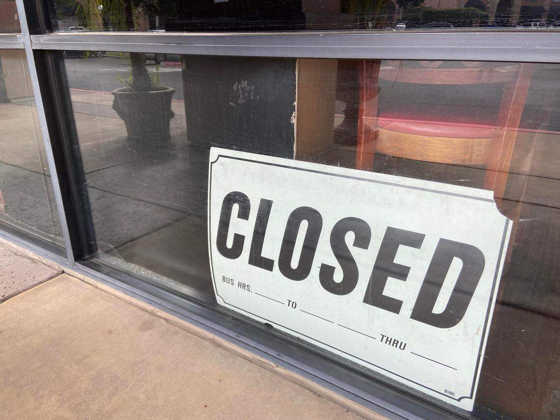 A closed sign sits in the window at Fort Blossom Cafe. The restaurant has not been open for weeks and its phone is disconnected. 