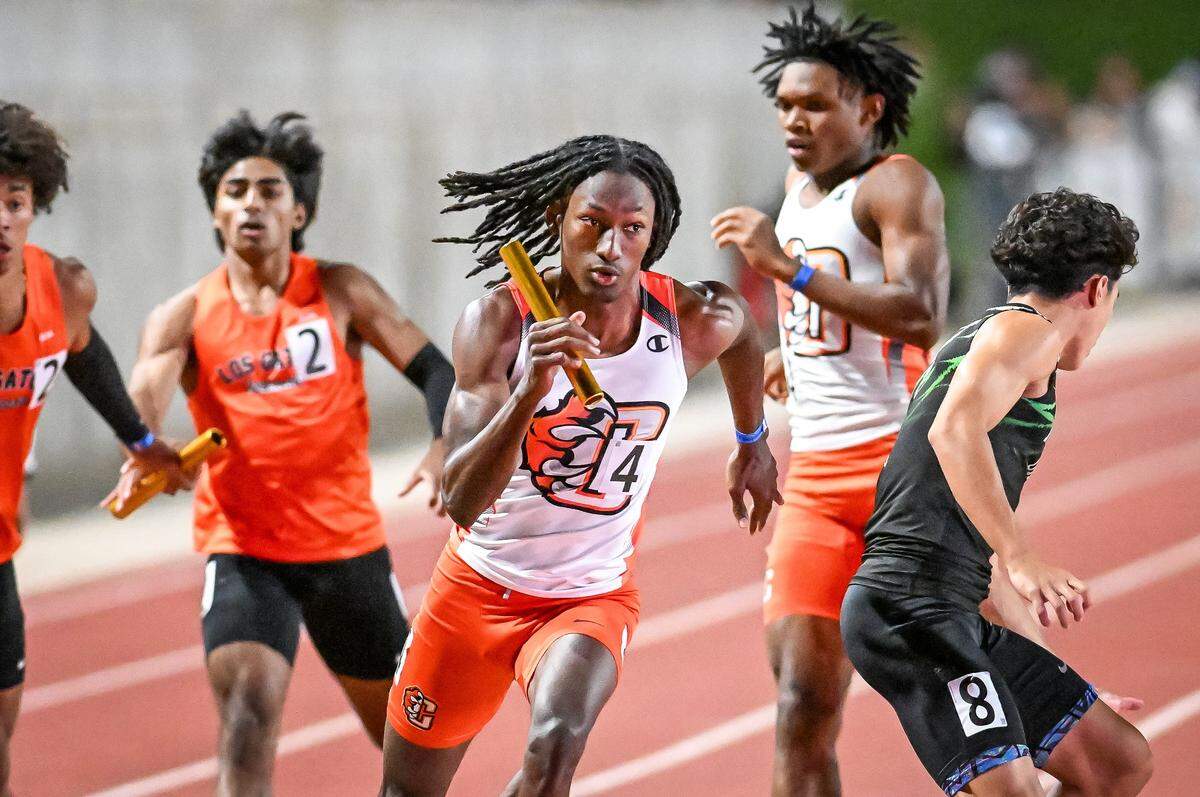 Central's Emanuel Morgan, center, takes the baton from teammate Xavior Jones in the boys' 1600 relay during the CIF state track and field championships at Veterans Memorial Stadium in Clovis on Saturday, May 30, 2026. The Central East team finished third.