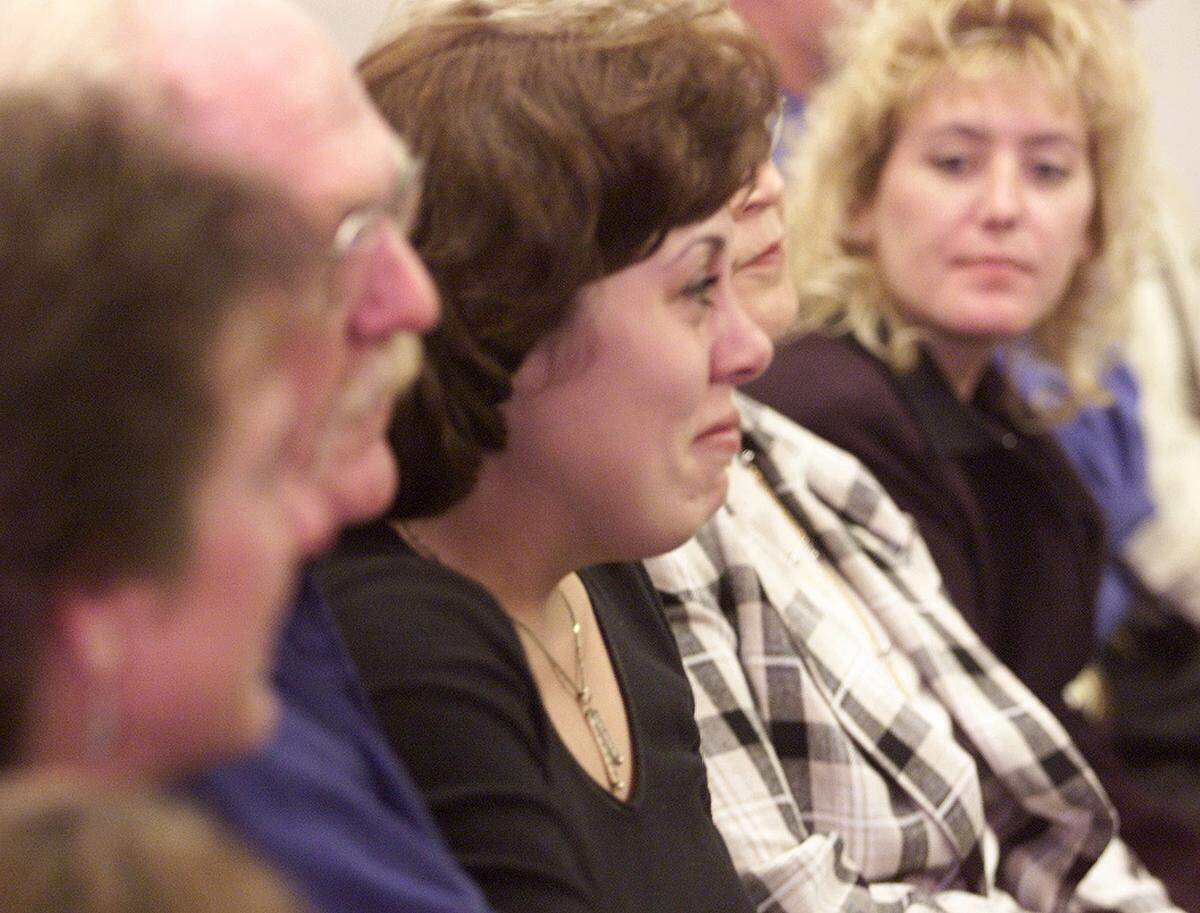 Wendy Isbell (center), sister of murder victim Scott George, smiles after the court clerk reads the jury’s recommendation of the death penalty in the case of Robert Acremant.  Acremant was convicted of murdering Scott George of Visalia and two Oregon women in late 1995.
