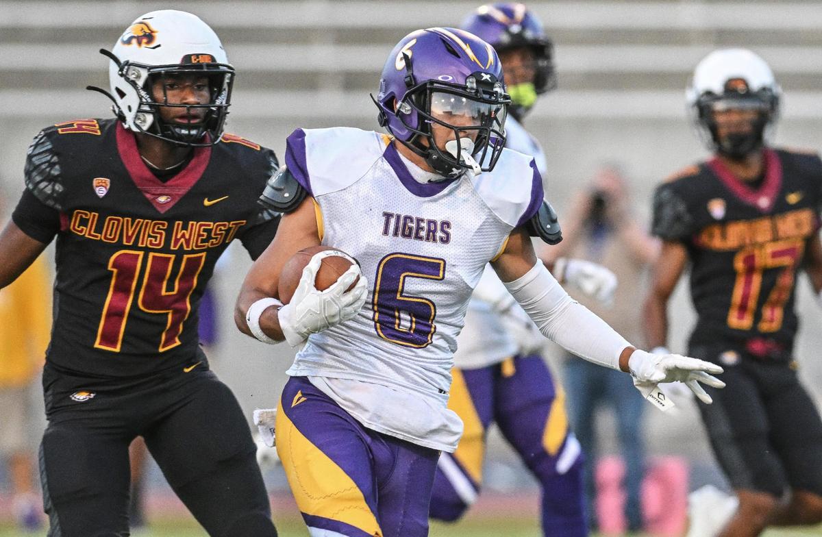 Lemoore’s Alex Morales weaves his way through the Clovis West defense on his way to a touchdown in the first half of their game at Veterans Memorial Stadium on Friday, Sept. 1, 2023.