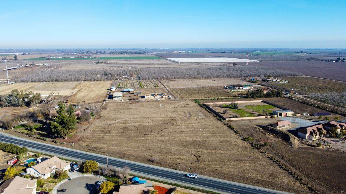 Orchards, large-acreage custom home sites, and more newly developed subdivisions converge along a highway in Hanford.