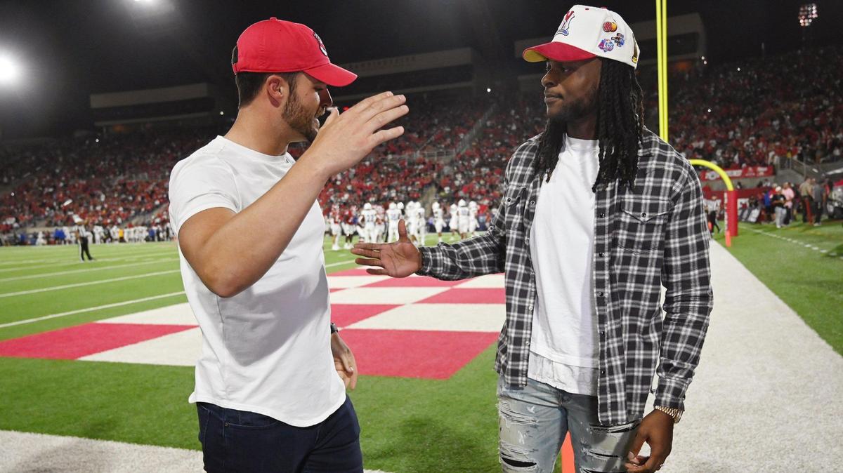 Derek Carr, left, extends his hand to Davante Adams, right, Saturday, Oct. 15, 2022 in Fresno.