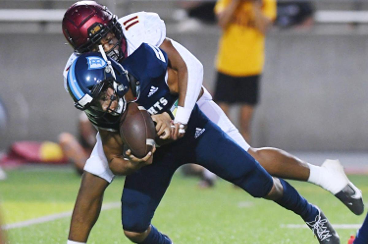 Clovis West’s Mychael Crawford, background, sacks Bullard quarterback Joshua Madrigal, foreground, in first quarter action Friday, Sept. 9, 2022 in Fresno.