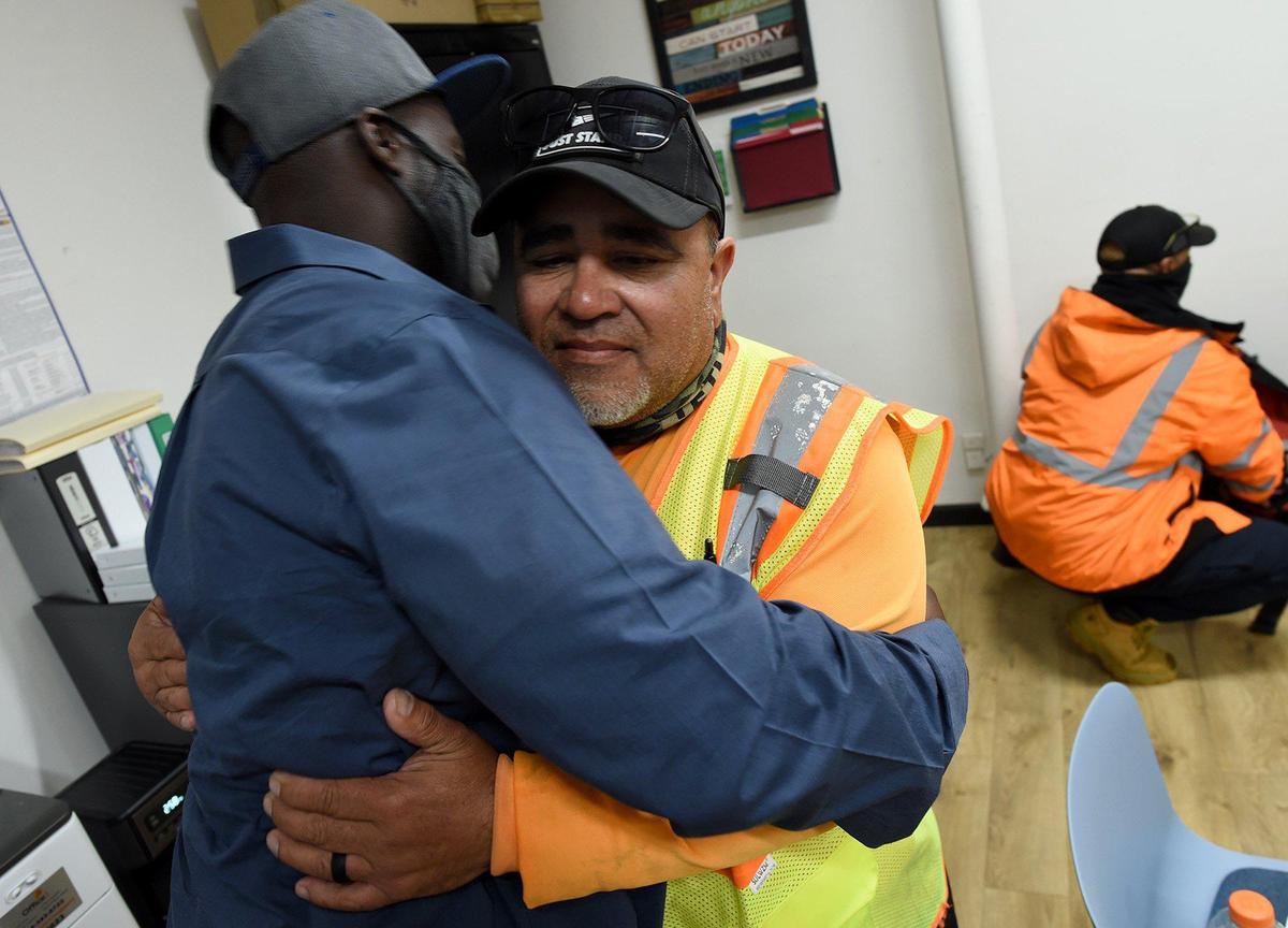 CEO (Center for Employment Opportunities) office worker, Christopher Williams, hugs Shane Lara, CEO site supervisor, on Lara’s last day of employment. CEO is a non-profit that provides job training and rehabilitation to formerly incarcerated people. Williams was given a second chance at employment through CEO after serving 15 years in prison for a second degree murder conviction, committed when he was a teen. JOHN WALKER jwalker@fresnobee.com