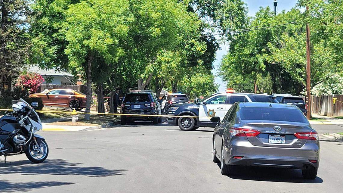 Police block off the scene in Fresno neighborhood where an officer shot and killed a suspect Thursday, May 19, 2022.