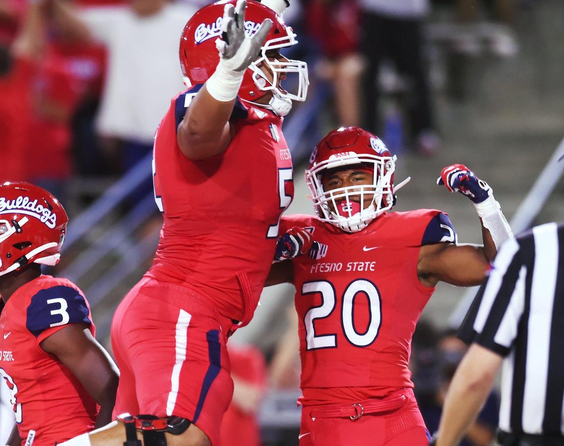 Fresno State guarrd Netane Muti, left, celebrates Ronnie Rivers’ touchdown reception, right, against Minnesota Saturday, Sept. 7, 2019 in Fresno. Minnesota led 14-10 at halftime