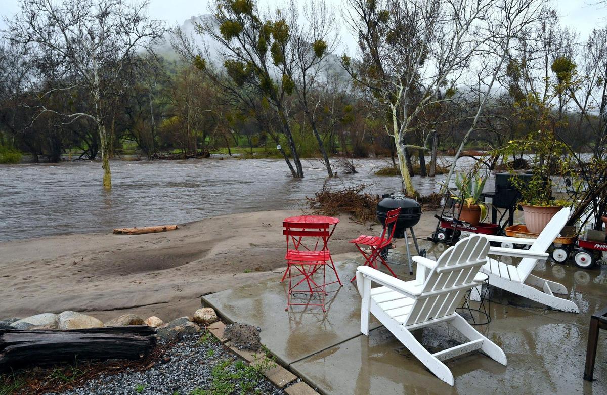 Patio chairs at Sequoia Riverfront Cabins face the rising Kaweah River Tuesday, March 14, 2023 in Three Rivers.