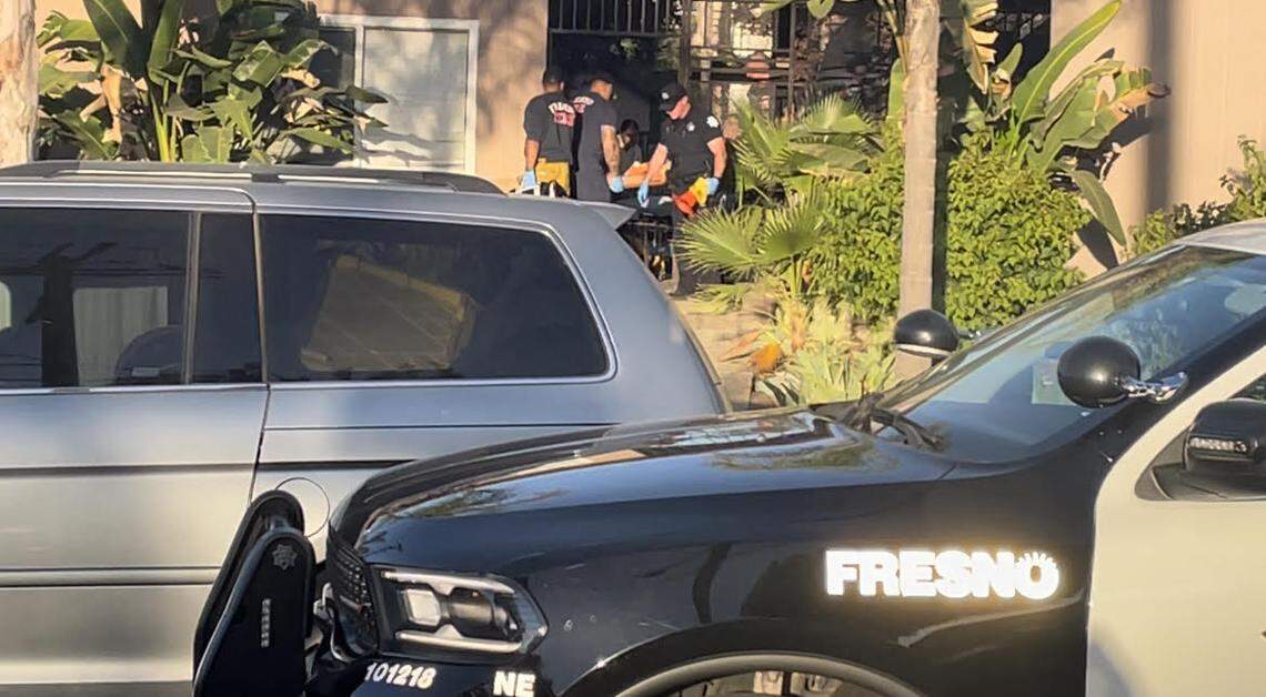 Firefighters help wheel a gunshot victim to an ambulance early Saturday in east-central Fresno. The man was shot in the leg.