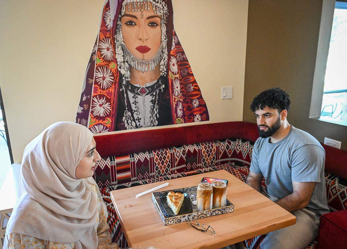 Asiyah Karim, left, and her husband Ibrahim Dastagir enjoy Yemeni coffee drinks and a honeycomb pastry at Qamaria Yemeni Coffee Co. in northwest Fresno.
