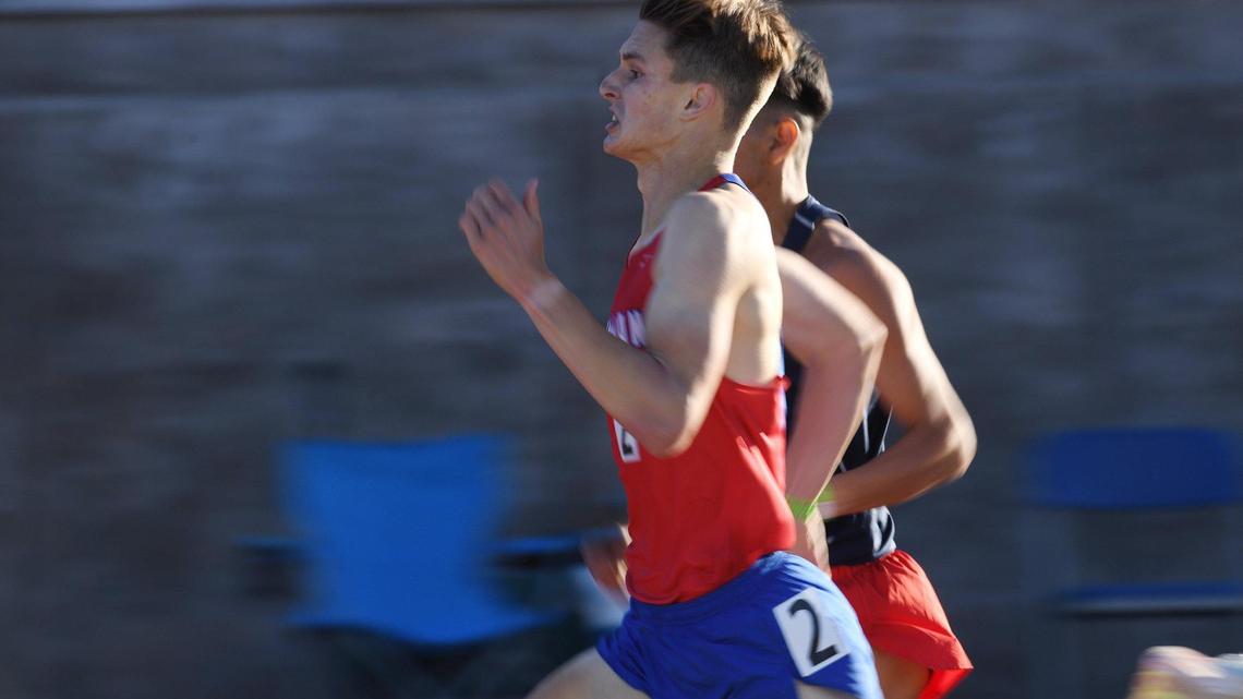 First place finisher Noah Ray from Buchanan, foreground, keeps ahead of second place finisher Emanuel Salas from Sanger, background, in the 800 at the Central Section Masters held at Buchanan High School Saturday, May 21, 2022 in Clovis.