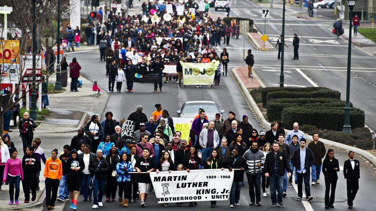 Participants march during the 2015 Martin Luther King Parade along Martin Luther King Jr. Way in Merced, Calif., Monday, Jan. 19, 2015.