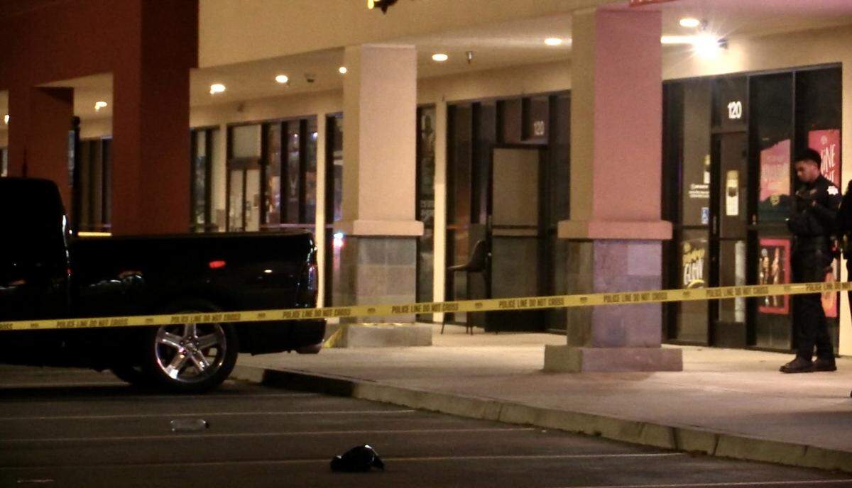 Police tape up the parking lot at Herndon Place at Milburn Avenue after one person was shot and killed and another critically injured at a Hookah Lounge in Fresno, California on Sunday, Feb. 19, 2023.