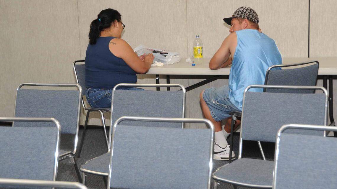 Two Merced residents avoid being out in the heat by relaxing in a cooling center at the Civic Center in 2012 when temperatures reached 106 degrees.