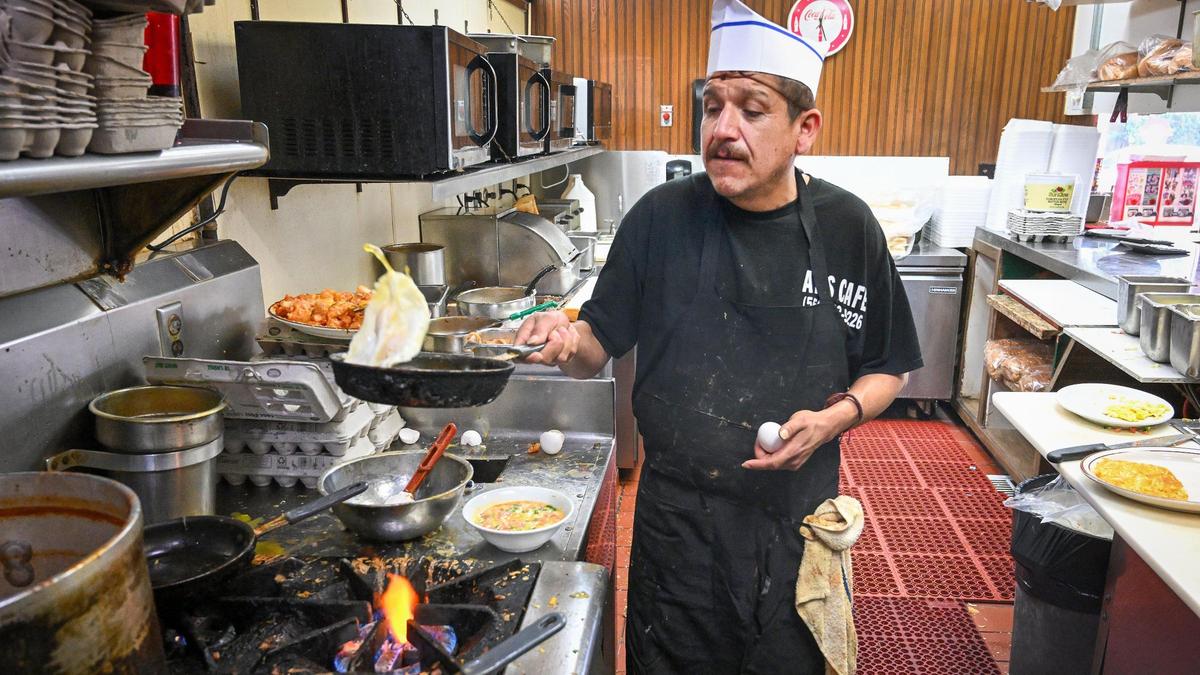 Alejandro Chavez flips eggs while working at Al’s Cafe in Fresno on Friday, Feb. 21, 2025. Higher egg prices have forced the restaurant to bump up prices for the first time in years to make up the difference.