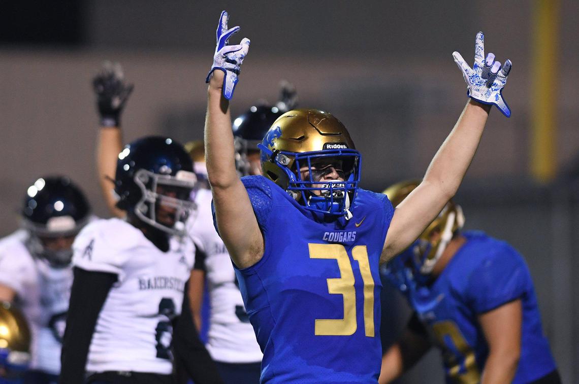 Clovis High’s Wyatt Merkord signals a touchdown against Bakerfield Friday, Aug. 27, 2021 in Clovis.