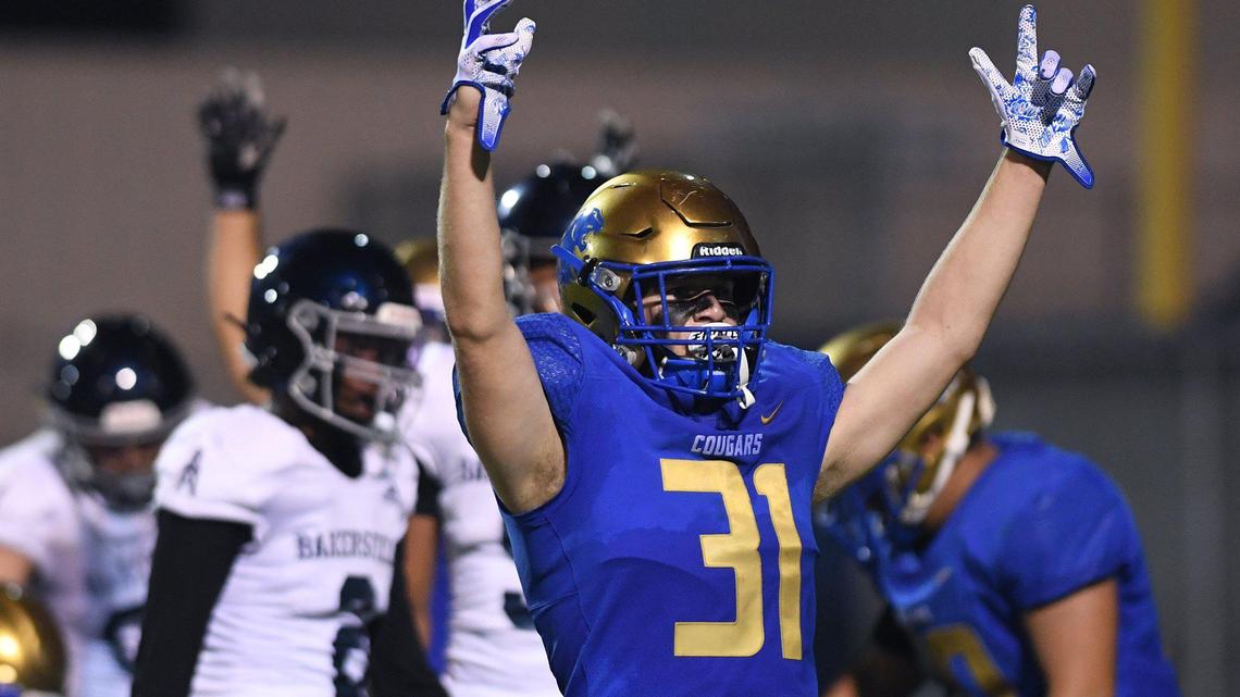 Clovis High’s Wyatt Merkord signals a touchdown against Bakerfield Friday, Aug. 27, 2021 in Clovis.