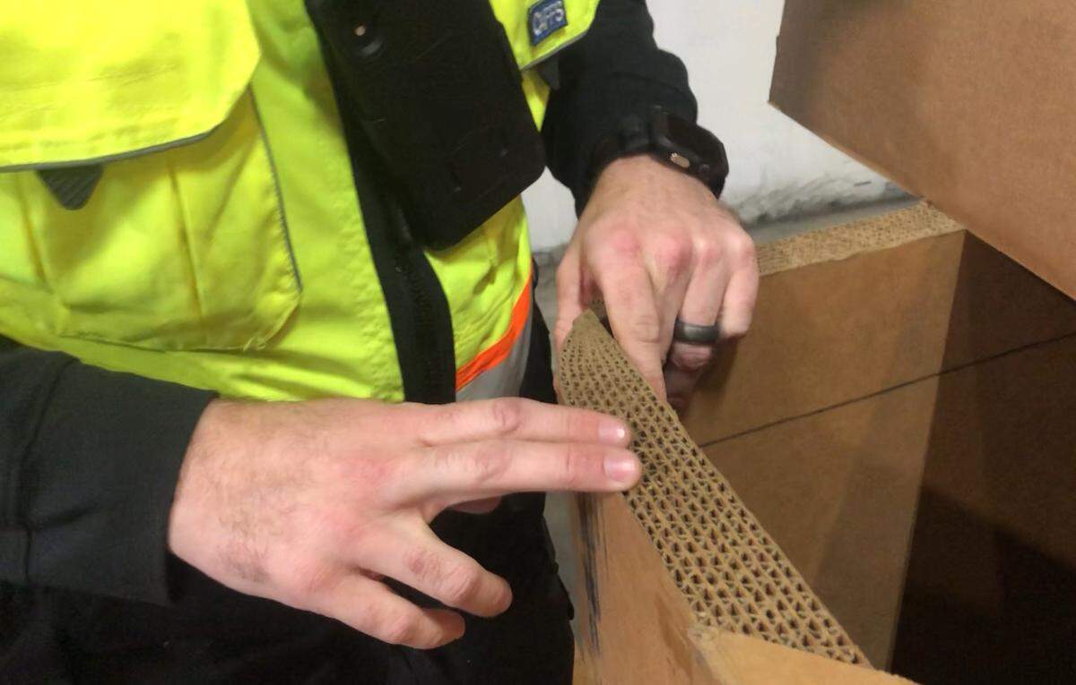 Kyle Goddard, operations support for Fresno’s Caylym Technologies, shows how thick the cardboard walls are on the company’s Guardian system, which can be used to drop water or fire retardant on wildfires from the rear of a cargo aircraft.