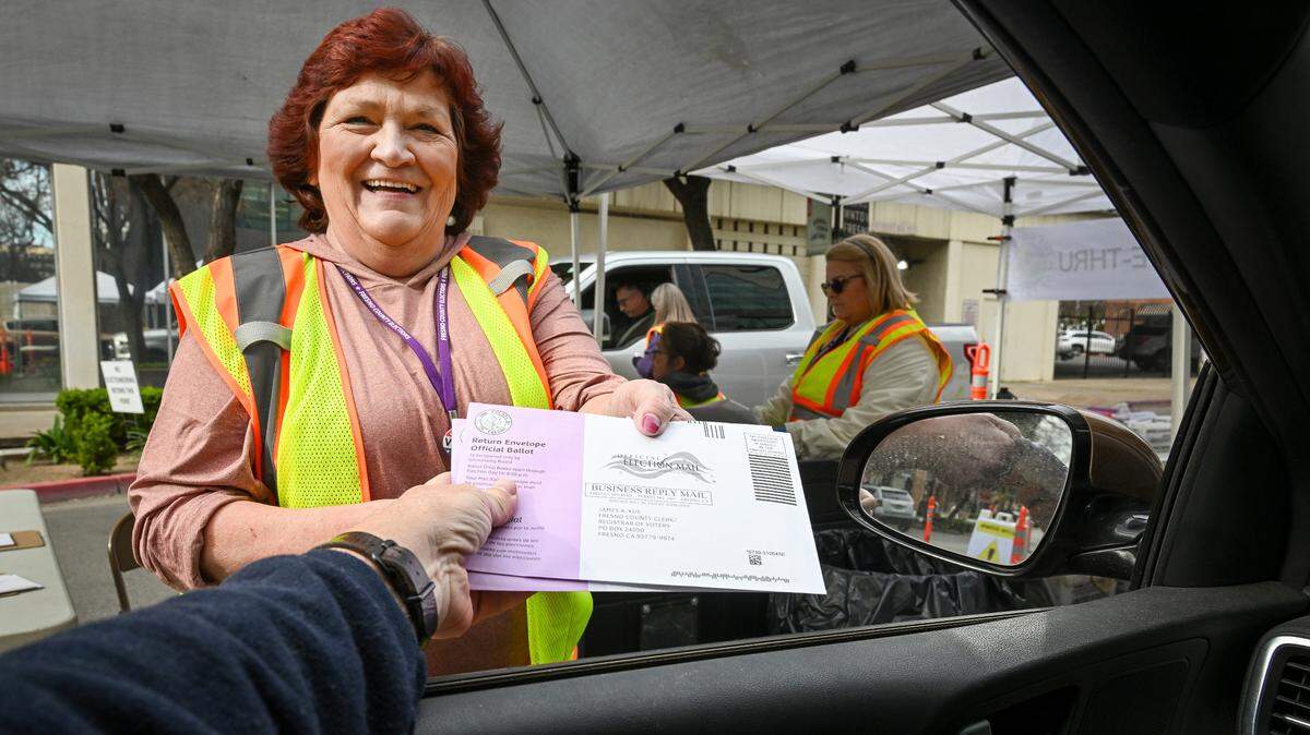 Donna Propes of the Fresno County Clerk/Registrar of Voters office accepts election ballots at the office’s drive-thru ballot drop-off location in downtown Fresno on Tuesday, March 5, 2024.