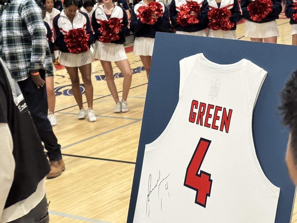 Jalen Green signs a jersey that will stay at San Joaquin Memorial.