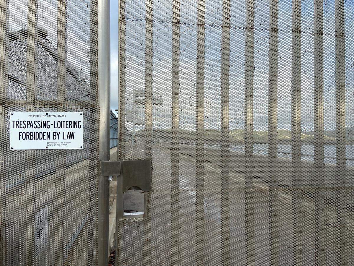A security fence prevents people from walking across Friant Dam near Friant, California, as photographed January 25, 2024. Millerton Lake is seen on the right.