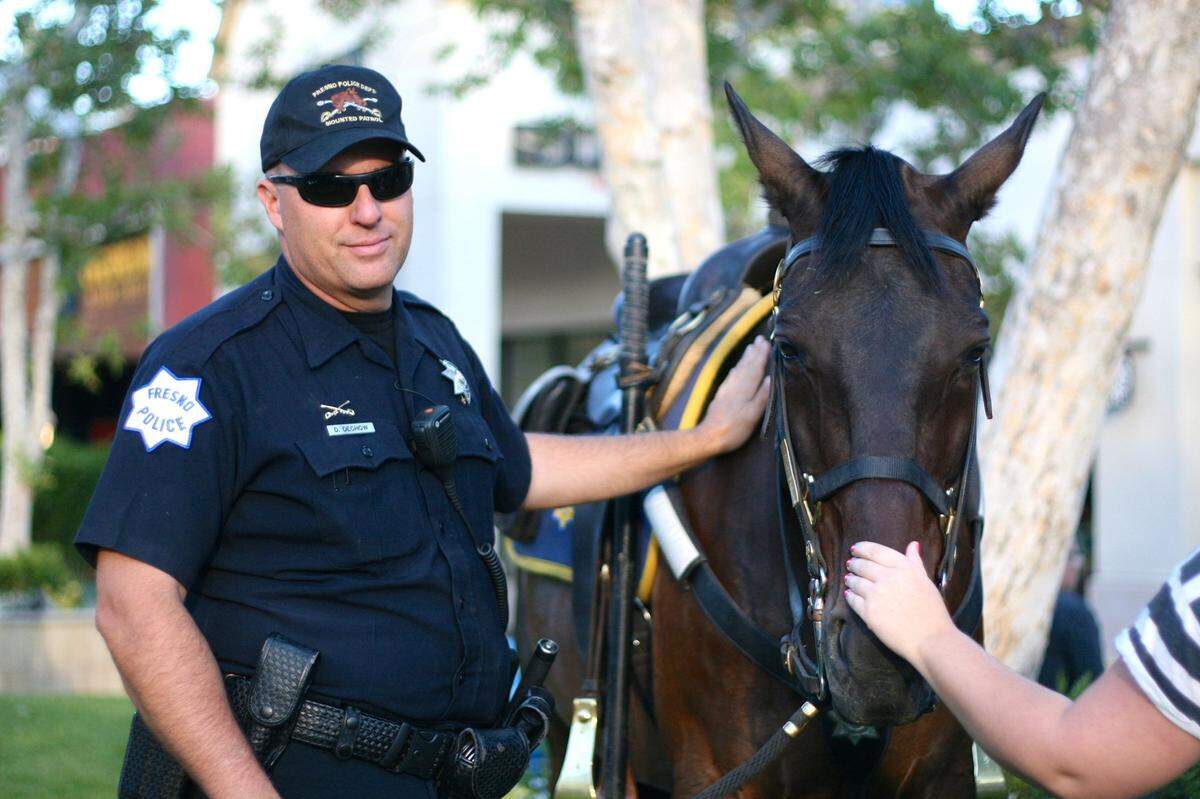 Officer Dave Dechow was featured in a Jun 22, 2016, edition of The Fresno Bee photographed next to a horse called Chief at a weekly farmers market at River Park Shopping Center.