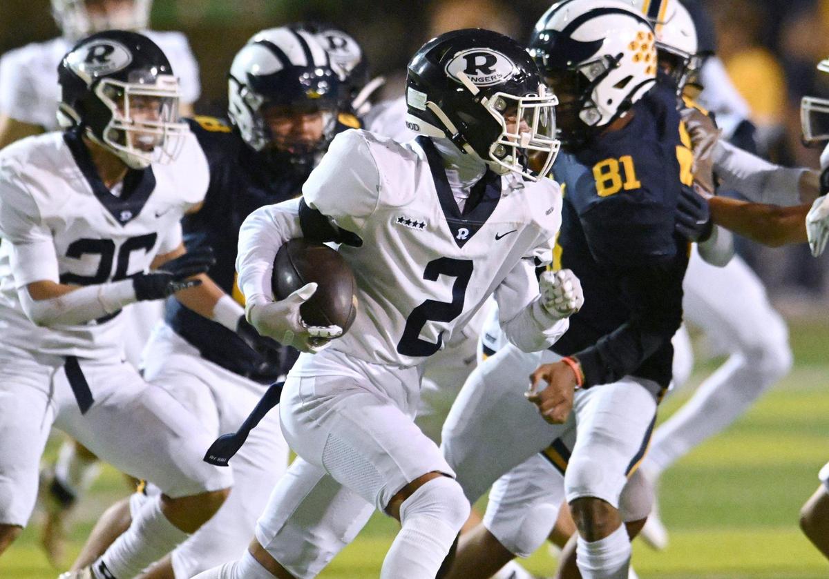 Redwood’s AJ Garza Jr., center, carries the ball on a run against Sunnyside in the Central Section D2 playoff game Friday, Nov. 3, 2023 in Fresno. Sunnyside led 12-7 at halftime.