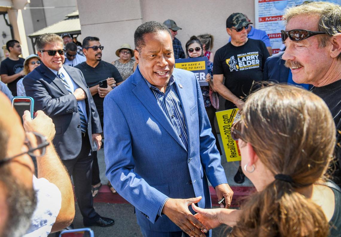 Republican candidate for California governor Larry Elder, center, greets supporters before giving a speech at the Shell gas station on Willow and Nees avenues in Clovis on Tuesday, Sept. 7, 2021.