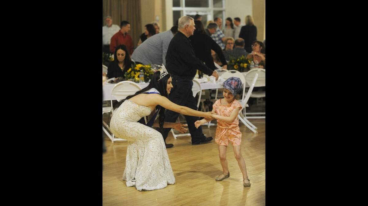 Miss May Day 2019 Holly Ballez, left, dances to the music of the Second Wind Band with a young friend during the Merced Spring Fair Kickoff Dinner Sat., April 13, 2019 in the O’Banion Building at the Los Banos Fairgrounds.