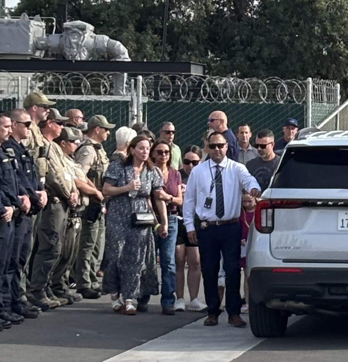 Family members are escorted out of the Tulare County Coroner’s Office, where the body of a deputy killed in the line of duty in Porterville was taken on Thursday, April 9, 2026.