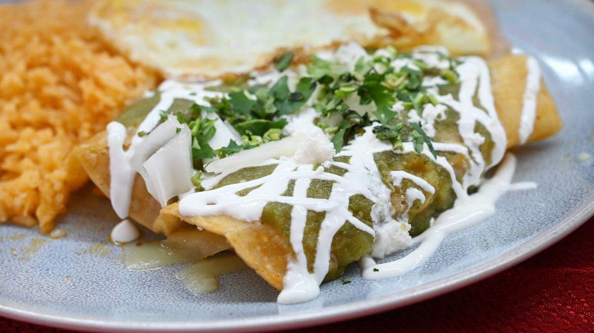 The chicken enchiladas montadas with fried egg, beans and rice is another popular dish served at Qué pasó Camarón?, located inside and at the back of El Toro Loco Market near Shields and West Avenues. Photographed Thursday, April 14, 2022 in Fresno.
