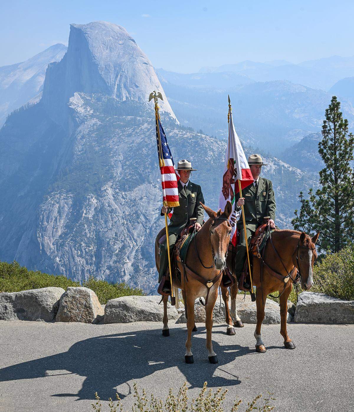 Members of the Yosemite National Park Mounted Patrol present the colors with Half Dome in the background before the start of a naturalization ceremony at Glacier Point Yosemite National Park on Wednesday, Sept. 17, 2025. 