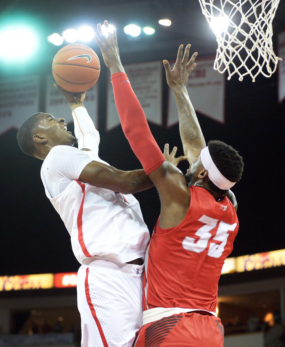Fresno State guard Braxton Huggins, left, tries to get a shot over New Mexico’s Carlton Bragg defending during the Bulldogs’ 82-70 victory at the Save Mart Center in Fresno on Saturday, Feb. 2, 2019. Huggins scored 22 points, 14 coming in the second half.