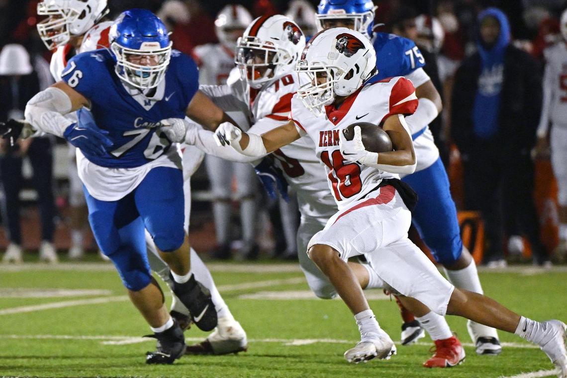 Kerman running back Jorge Antunez, right, finds a hole in the Madera defense in the Central Section DIII championship held Friday, Nov. 29, 2024 in Madera. Kerman won the championship game beating Madera 42-28.