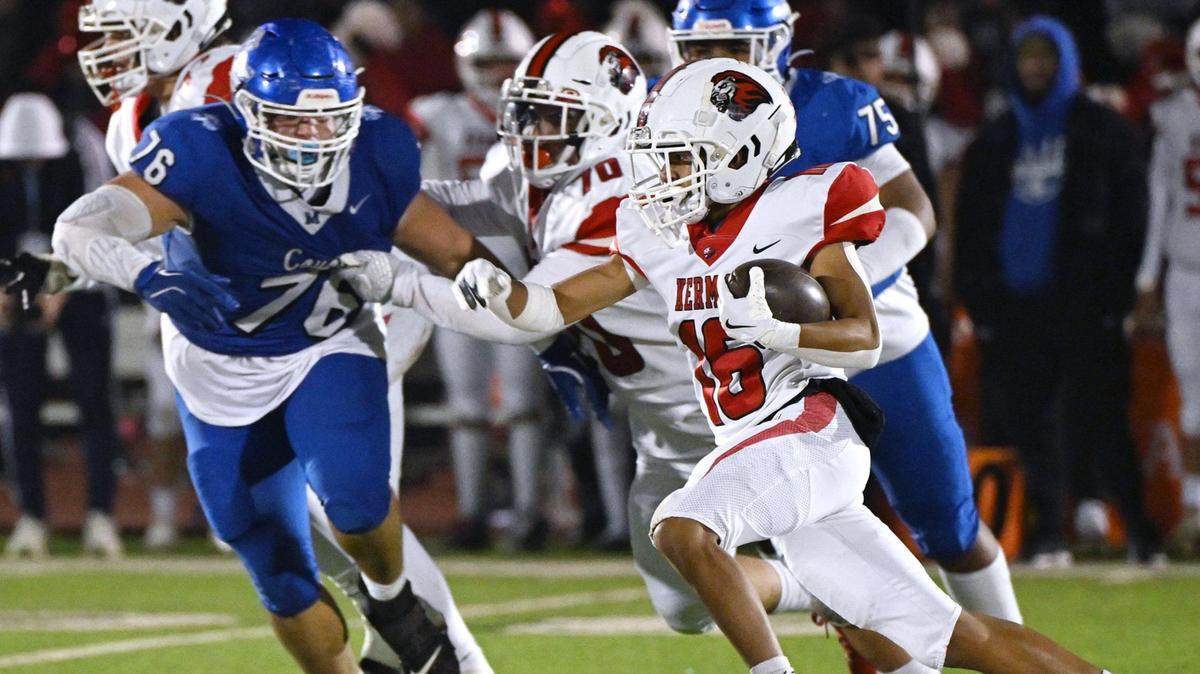 Kerman running back Jorge Antunez, right, finds a hole in the Madera defense in the Central Section DIII championship held Friday, Nov. 29, 2024 in Madera. Kerman won the championship game beating Madera 42-28.